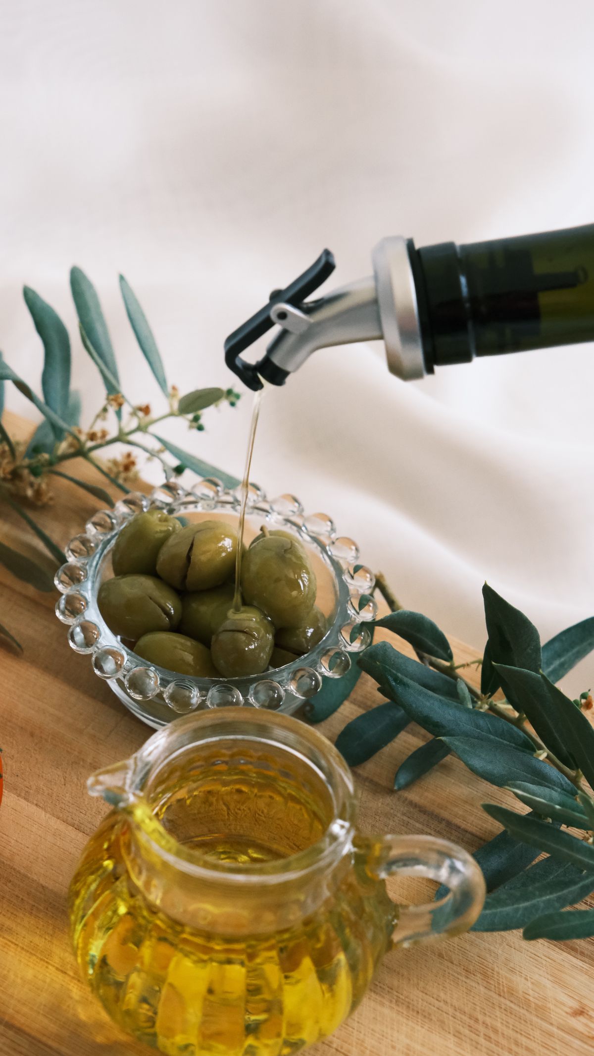 One ingredient at its source: saffron stigmas drying on a rack in La Mancha, or the first cold press of Puglian olives. Hands in the work, golden hour, a real place you could name.