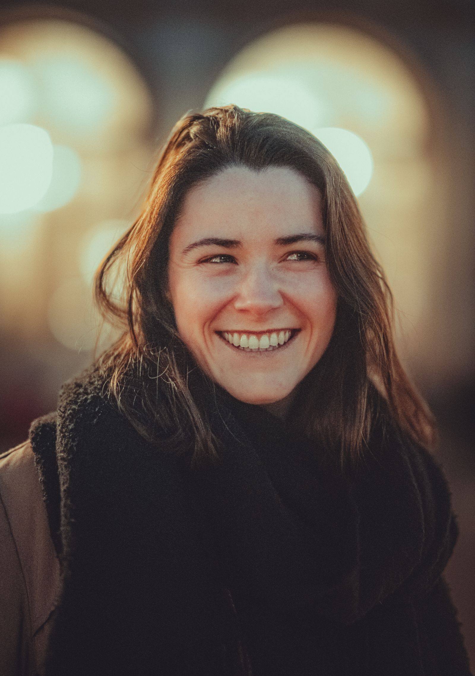 A real customer mid-laugh in warm natural light — the kind of person who reads the label and still smiles.